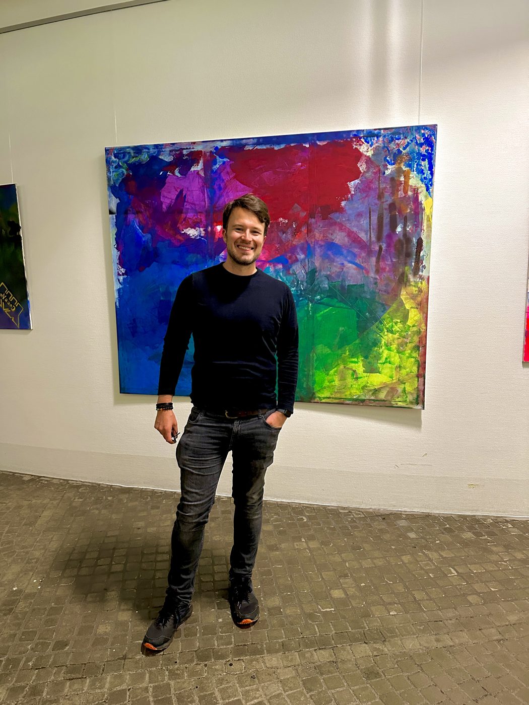 Moritz Rossmanith with his painting at the University of Ulm exhibition, 2024