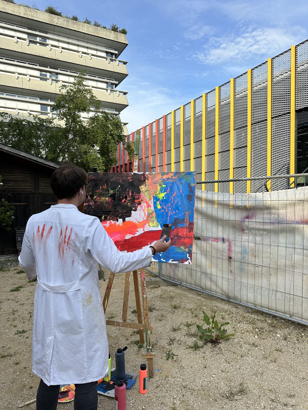Moritz painting at the easel outside his atelier